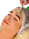 Mud facial mask of woman in spa salon. Face massage . Royalty Free Stock Photo