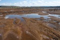 Mud in front of boardwalk and Twin Barns in the Billy Frank Jr. Nisqually National Wildlife Refuge, WA, USA