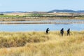 Mud spa treatments outdoor. Three unrecognizable people smeared with black healing mud. Natural SPA In Pomorie, Bulgaria