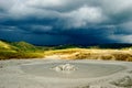 Mud volcano crater and dramatic background Royalty Free Stock Photo