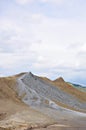 Mud volcanoes beneath cloudy sky Royalty Free Stock Photo