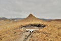 Mud Volcanoes and a sky with clouds Royalty Free Stock Photo