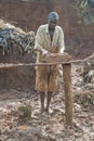 Mudbrick former standing barefoot in clay in Uganda