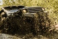 Mudding is off-roading through an area of wet mud or clay. Track on mud. Motion the wheels tires and off-road that goes