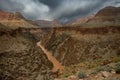 Muddy Colorado River Cuts Through The Grand Canyon Covered In Dark Clouds Royalty Free Stock Photo