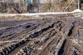 A muddy country road on the edge of the forest in early spring