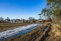 A muddy country road on the edge of the forest in early spring Royalty Free Stock Photo