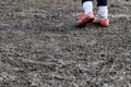 muddy football field with muddy player