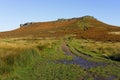 A rutted muddy footpath leads up the steep sloping sides of Higger Tor to its summit.