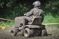 Muddy man working with the mower tractor in the countryside Royalty Free Stock Photo