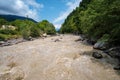 Muddy mountain river flowing