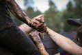 Muddy obstacle race runner in action. Mud run