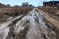 Muddy road with a deep track in the village travel is impossible in a puddle in the summer Royalty Free Stock Photo