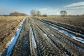 Muddy road with melting snow, plowed fields Royalty Free Stock Photo