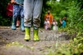 Muddy shoes of a child walking in a forest after rain Royalty Free Stock Photo