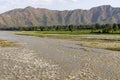 Muddy water in the river swat along a beautiful rice fields at the riverbank