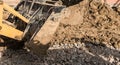 Muddy wheels of an excavator bulldozer truck working on a construction site