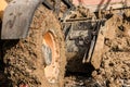 Muddy wheels of an excavator bulldozer truck working on a construction site
