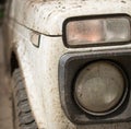 Muddy White Jeep and Headlight