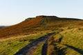 Following a muddy, winding footpath up to the top of Higger Tor in the Derbyshire Peak District.