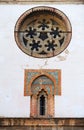 Mudejar style window with tiles -alicatados- and rose window of the church of Omnium Sanctorum in Seville, Spain