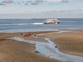 Mudflat hiking and ferry in WittdÃÂ¼n channel, Amrum island, North Frisia, Schleswig-Holstein, Germany Royalty Free Stock Photo