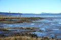 Mudflats at low tide with mountains on the horizon