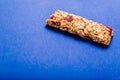 Muesli bar on a deep blue background Royalty Free Stock Photo