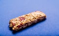 Muesli bar on a deep blue background Royalty Free Stock Photo