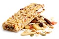 Muesli bar on heap of fruit, seeds and nuts.