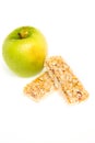 Muesli bars dried fruit on isolated background with apple Royalty Free Stock Photo