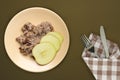 Muesli on a beige plate on a green brown background. granola with fruits apple on a plate top view. healthy eating. healthy Royalty Free Stock Photo