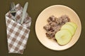 Muesli on a beige  plate on a green brown  background. granola with fruits apple  on a plate top view. healthy eating. healthy Royalty Free Stock Photo