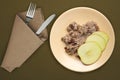 Muesli on a beige  plate on a green brown  background. granola with fruits apple  on a plate top view. healthy eating. healthy Royalty Free Stock Photo