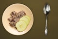 Muesli on a beige  plate on a green brown  background. granola with fruits apple  on a plate top view. healthy eating. healthy Royalty Free Stock Photo