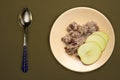 Muesli on a beige plate on a green brown background. granola with fruits apple on a plate top view. healthy eating. healthy Royalty Free Stock Photo