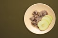 Muesli on a beige  plate on a green brown  background. granola with fruits apple  on a plate top view. healthy eating. healthy Royalty Free Stock Photo