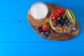 Muesli with berries and fruits on blue wooden background Royalty Free Stock Photo
