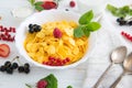 Muesli with berries and milk Healthy tasty breakfast cornflakes with strawberries, raspberries, black currants and red Royalty Free Stock Photo