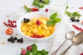 Muesli with berries and milk Healthy tasty breakfast cornflakes with strawberries, raspberries, black currants and red Royalty Free Stock Photo