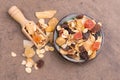 Muesli in a bowl on a brown textured background Royalty Free Stock Photo