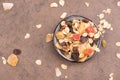 Muesli in a bowl on a brown textured background Royalty Free Stock Photo