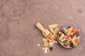 Muesli in a bowl on a brown textured background Royalty Free Stock Photo