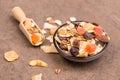 Muesli in a bowl on a brown textured background Royalty Free Stock Photo