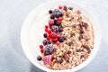 Muesli bowl or granola bowl with yogurt and berries on concrete table top. Healthy breakfast, top view. Dish suitable for diet, Royalty Free Stock Photo
