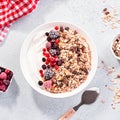 Muesli bowl or granola bowl with yogurt and berries on concrete table top. Healthy breakfast, top view. Dish suitable for diet, Royalty Free Stock Photo