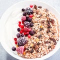 Muesli bowl or granola bowl with yogurt and berries on concrete table top. Healthy breakfast, top view. Dish suitable for diet, Royalty Free Stock Photo