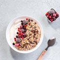 Muesli bowl or granola bowl with yogurt and berries on concrete table top. Healthy breakfast, top view. Dish suitable for diet, Royalty Free Stock Photo