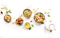 Muesli bowl, organic ingredients for healthy breakfast Granola, nuts, dried fruits, oatmeal, whole grain flakes on white
