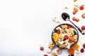 Muesli bowl and organic ingredients for healthy breakfast. Granola, nuts, dried fruits, oatmeal, whole grain flakes on white table Royalty Free Stock Photo